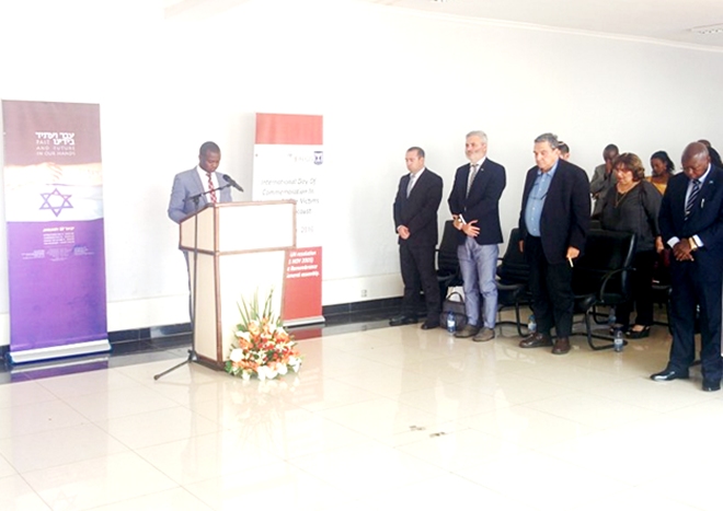 Freddy Mutanguha of Aegis Trust leads guests in a moment of silence to conclude today's Holocaust Remembrance Event.