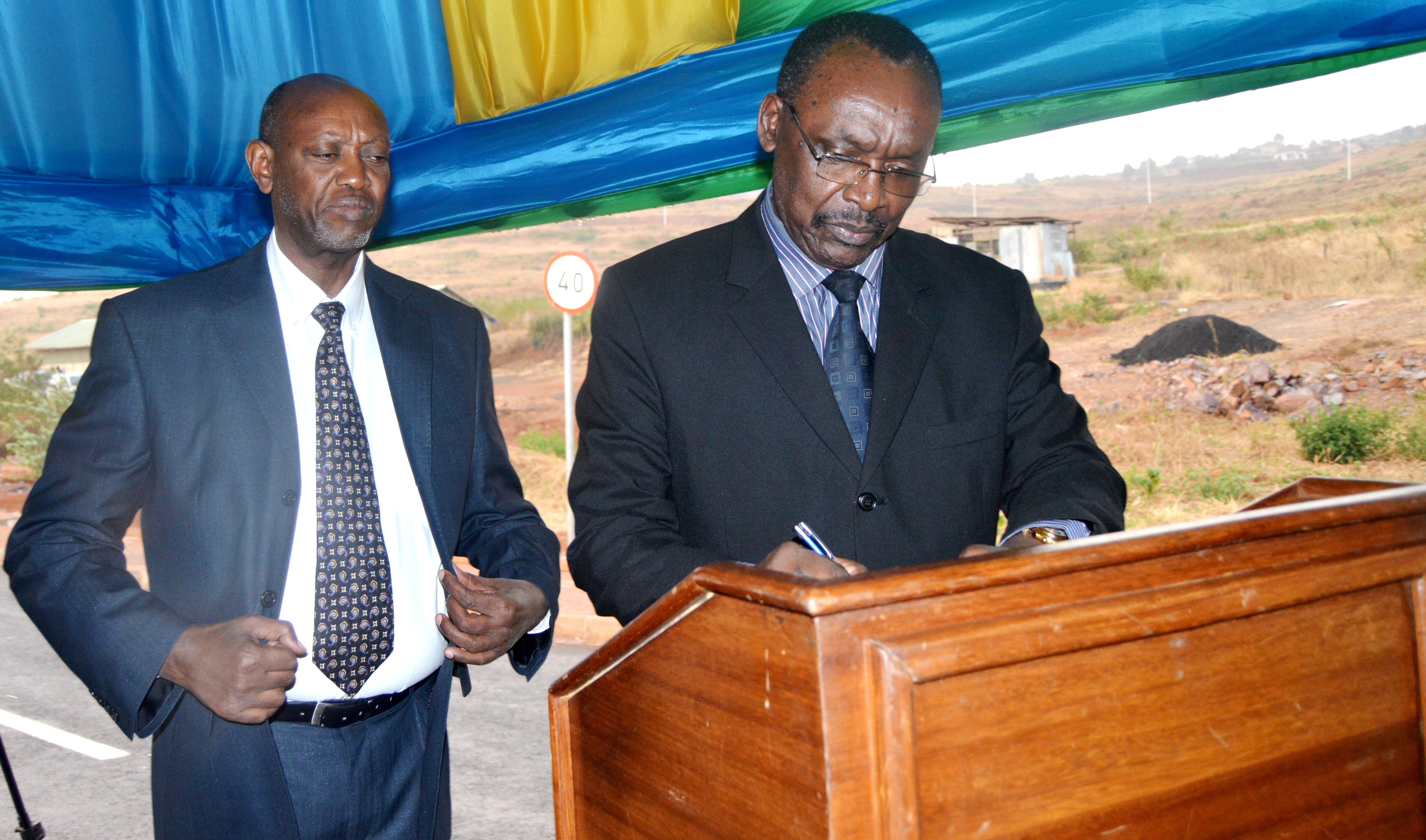 Rwanda's Minister of trade and industry Francois Kanimba signing 