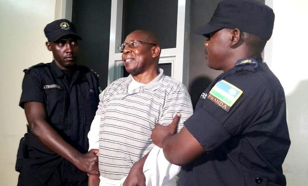 Dr. Leopold Munyakazi handcuffed upon arrival at Kigali International Airport