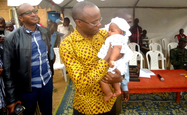 Gicumbi district Mayor holds baby that had been stolen (photos /Eric Muvara)