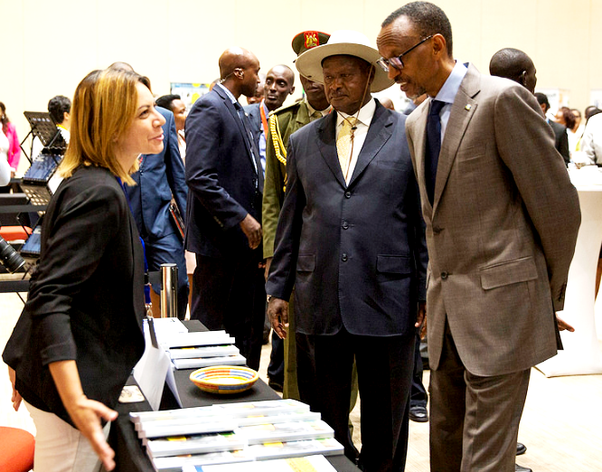 President Paul Kagame and President Yoweri Museveni listen to an exhibitor at The Global African Investment Summit