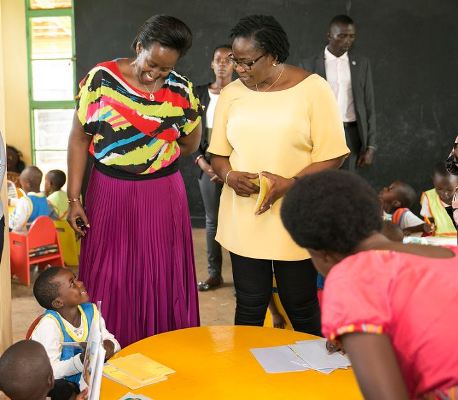 The First Lady of Benin Claudine Talon(R) interacts with children