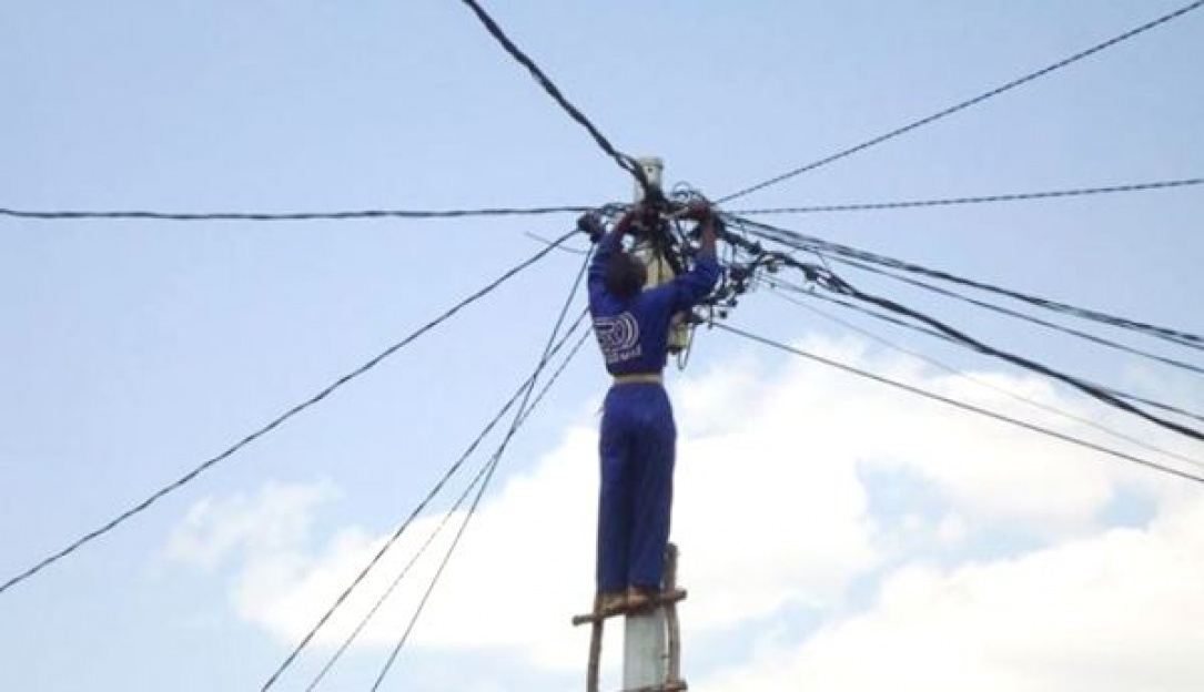 Technician connecting several subscribers to national grid